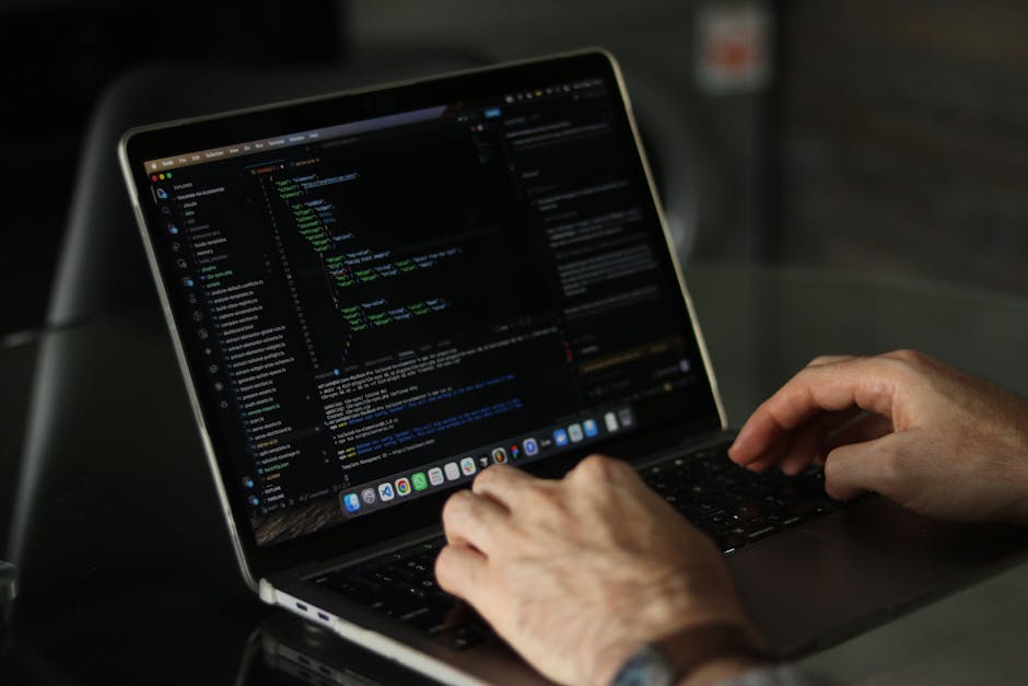 The image shows a close-up of a computer screen displaying lines of code in a text editor, with syntax highlighting in vibrant colors such as yellow, blue, purple, and green on a dark background. The 